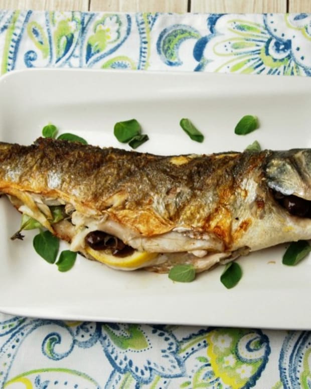 whole grilled branzino with olives and lemon