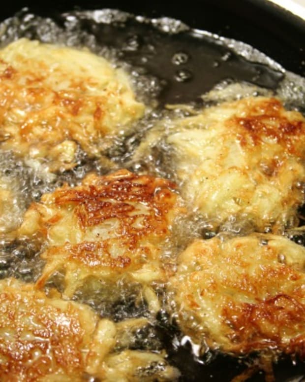 Potato latkes for Hanukah frying in oil.