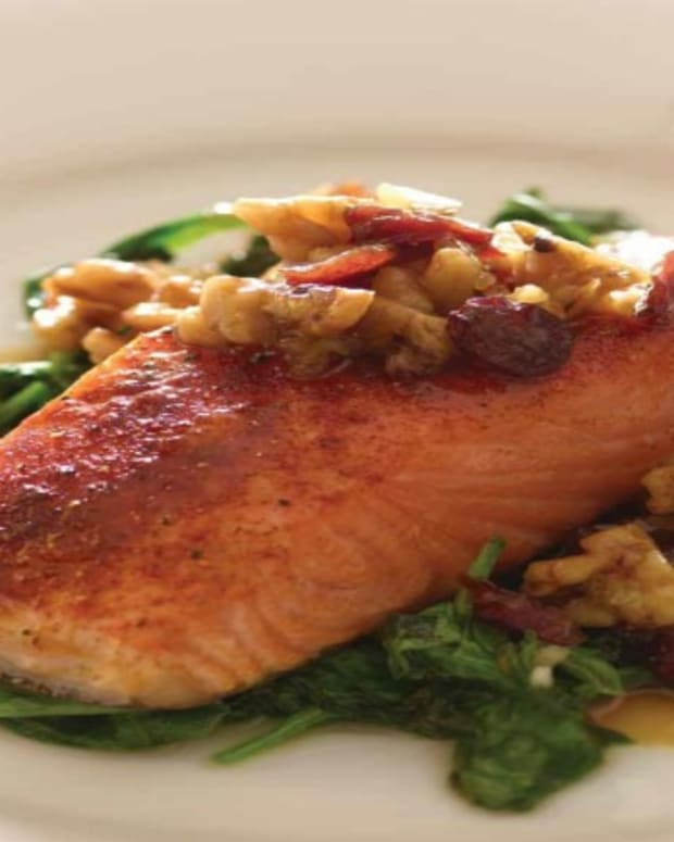 cranberry walnut salmon on a bed of spinach