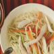 crystal clear chicken soup with julienned vegetables and angel hair