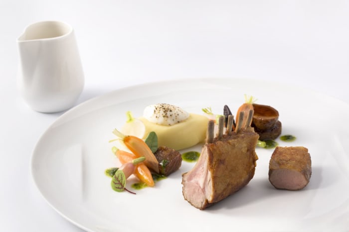 ROASTED LAMB RIBS SERVED WITH RATTE POTATO CREAM AND ROOT VEGETABLES WITH STAR ANISE AROMA, IN A RED WINE JUS