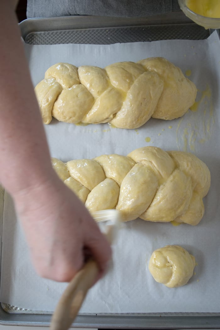 Brush with egg wash two times. Once right after you turn on the oven, and once again once the oven comes to temperature.