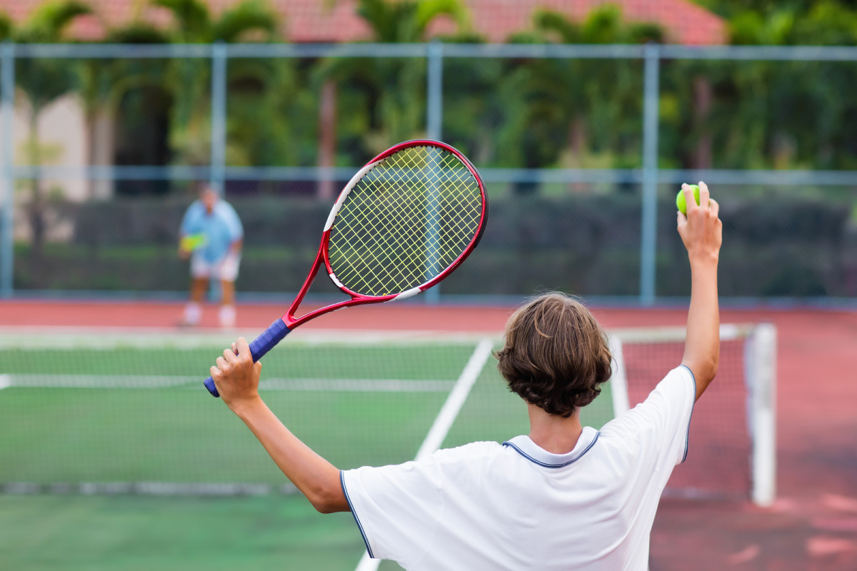 bigstock-Child-Playing-Tennis-On-Outdoo-204207586