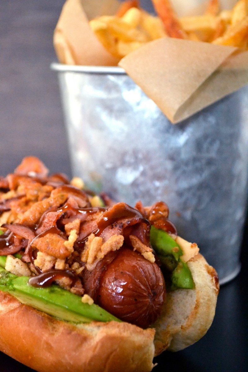 Sausage wrapped with Turkey bacon and topped with avocado and crispy onions