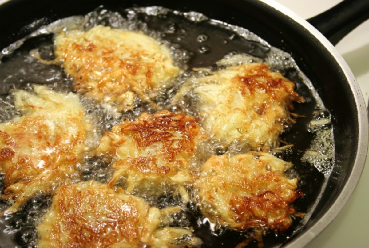 Potato latkes for Hanukah frying in oil.