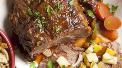 Braised pot roast with prunes, ancho chilis, golden raisins and roasted apples