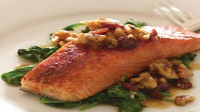 cranberry walnut salmon on a bed of spinach