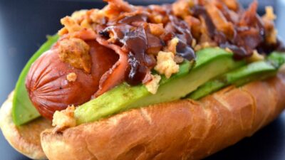 Sausage wrapped with Turkey bacon and topped with avocado and crispy onions