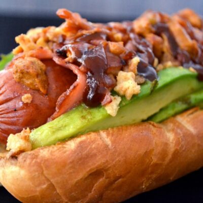 Sausage wrapped with Turkey bacon and topped with avocado and crispy onions