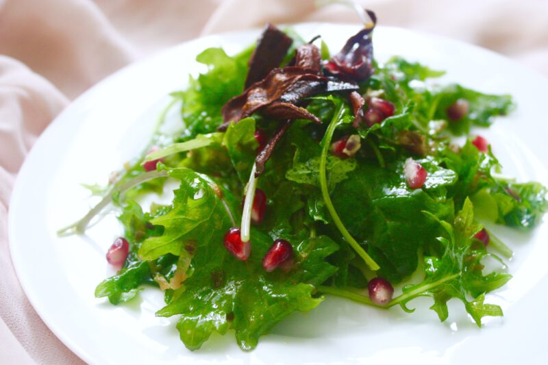 Kale salad with caramelized leek vinaigrette and carrot bacon