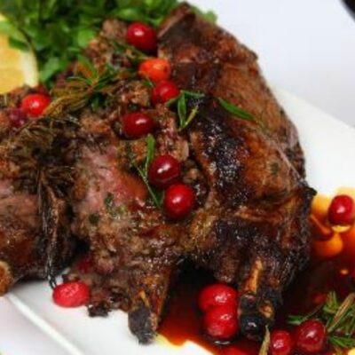Roasted veal rib eye stuffed with cranberries, dates, sage & rosemary