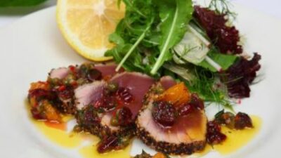 Seared peppered yellow fin tuna with dried cranberries, orange, chilli & dill