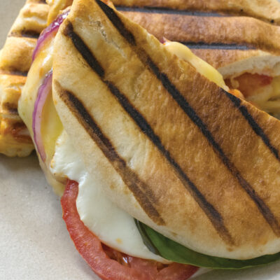 three cheese pita panini with basil, red onion and tomatoes