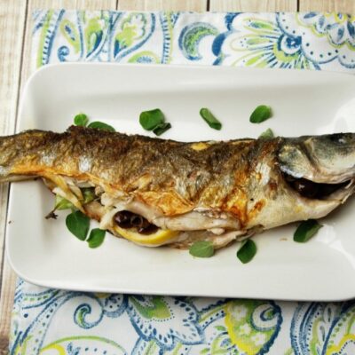 whole grilled branzino with olives and lemon