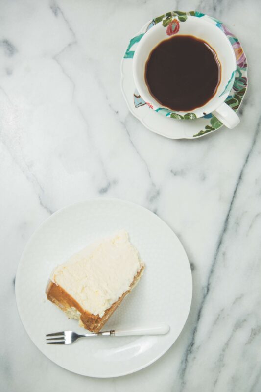Slice of cheesecake with coffee
